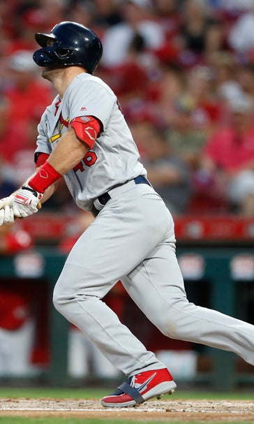Cardinals take over first place with 13-4 romp over Reds